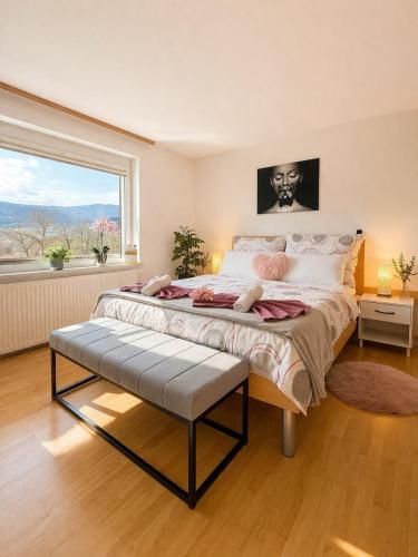 a bedroom with a large bed with a large window at Bled Vista Apartments in Bled