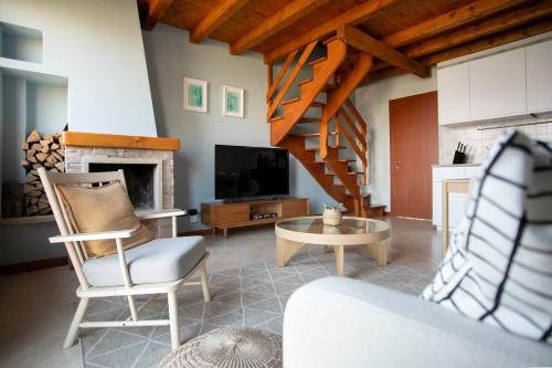 a living room with a couch and a tv and a fireplace at Lake Iseo View Retreat - Quiet & Nature in Fonteno