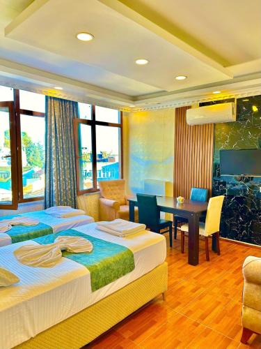a hotel room with two beds and a dining room at Sultanahmet Lİfe Apart in Istanbul