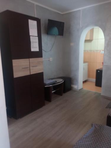 a room with a desk and a tall cabinet at Casa Octavia in Tulcea