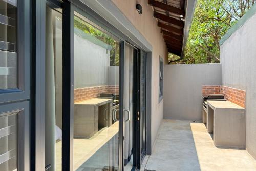 a glass door leading to a patio with two sinks at Elements Private Golf Reserve 109 in Moheme