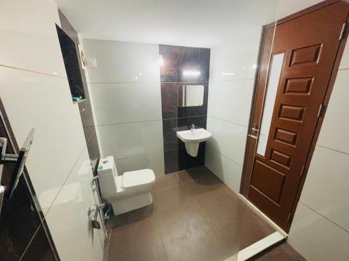 a small bathroom with a sink and a toilet at THE iVORY VILLA in Kottayam