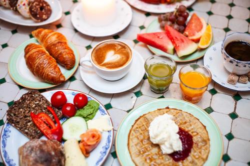 a table topped with plates of breakfast foods and coffee at MJ's in Malmö