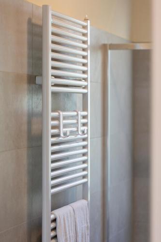 a bathroom with a towel rack and a shower at Villa Viadeipini22 in Bellagio
