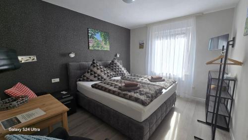 a small bedroom with a bed and a table at Pension Hendriks in Cochem