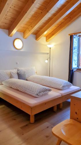 a large wooden bed sitting in a room at Gasthaus Alpenrose in Innerferrera