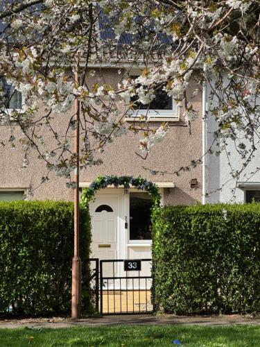 a house with a white door and a fence at Edinburgh Home from Home in Edinburgh
