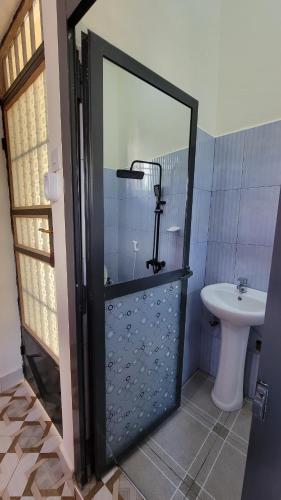 a bathroom with a shower with a toilet and a sink at Mamayi Homestay in Mto wa Mbu