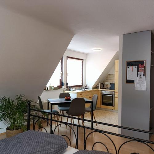 a kitchen and dining room with a table and chairs at Urban Apple in Bad Mergentheim