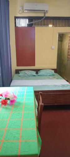 a bedroom with two beds with a green comforter at Lighthouse Peacock Villa in Dondra West