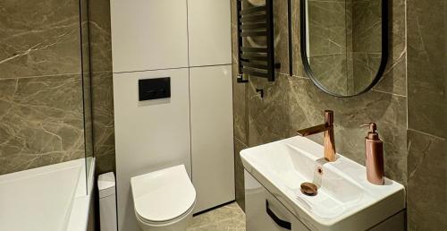 a bathroom with a toilet and a sink at Apartaments Jaunyste Free parking, Self Check - in in Klaipėda