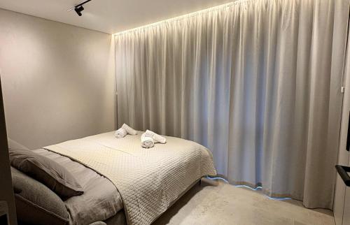 a bedroom with a bed with towels on it at Apartaments Jaunyste Free parking, Self Check - in in Klaipėda
