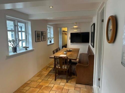 a dining room with a table and chairs in a room at Tøndegården 3 rooms apartment in Odense