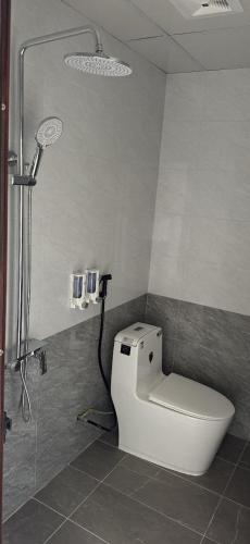 a bathroom with a toilet and a shower at Serena Xuân Thành Hotel in Hà Tĩnh