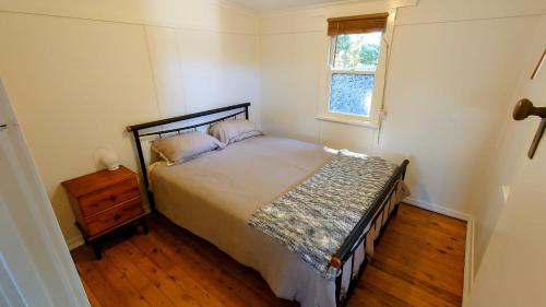 a bedroom with a large bed and a window at Home in Newtown in Toowoomba
