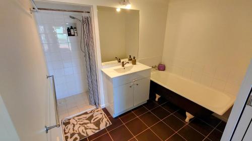 a bathroom with a sink and a shower and a tub at Home in Newtown in Toowoomba