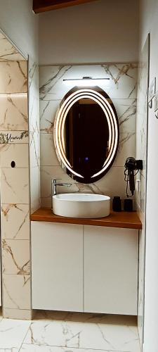 a bathroom with a sink and a mirror at Hercules casa in Kymi