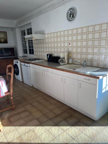 a kitchen with a sink and a counter top at Le Petit Clos périgourdin in Église-Neuve-de-Vergt