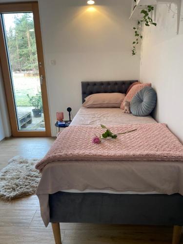 a bedroom with a large bed with a pink bedspread at River & Forest Escape, Private Garden Room near Ljubljana in Preddvor