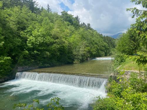 a waterfall in the middle of a river at River & Forest Escape, Private Garden Room near Ljubljana in Preddvor