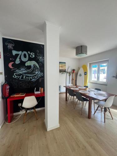 a dining room with a table and chairs at 70's Hostel in Ericeira