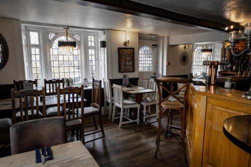 a restaurant with a bar and tables and chairs at The Kings Head Rye in Rye