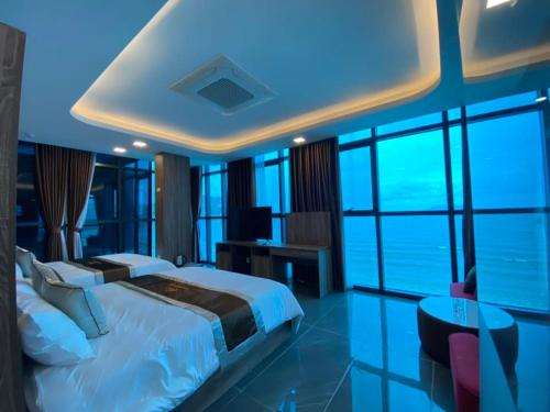 a bedroom with a large bed with a view of the ocean at Hải Phát Hotel in Du Xuyên