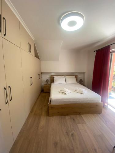 a bedroom with a bed and a large window at Harmony Home in Kouspádes