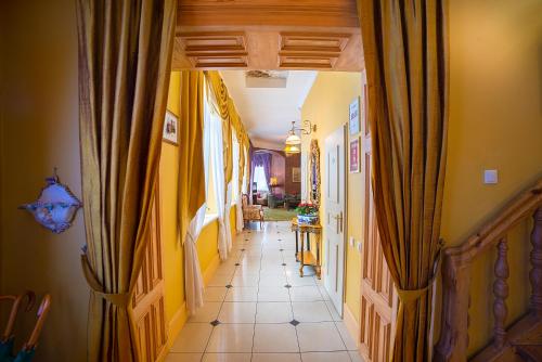 a hallway of a house with yellow walls at Marcienas Muiza & SPA in Mārciena