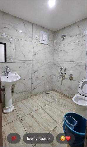 a bathroom with a sink and a toilet at Pause Dwelling Mcleodgunj Dharamshala in Dharamshala