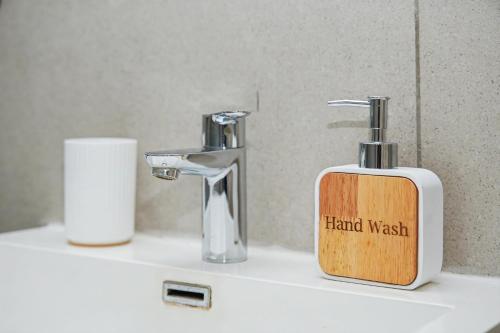 a soap dispenser sitting on a bathroom sink at Casa Solis at Wild Olive in Windhoek