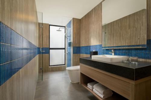 a bathroom with a sink and a toilet at Four Points by Sheraton Pontianak in Pontianak