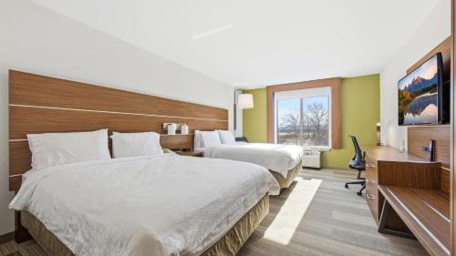 a hotel room with two beds and a desk at Holiday Inn Express & Suites Bethlehem Airport-Allentown Area in Bethlehem