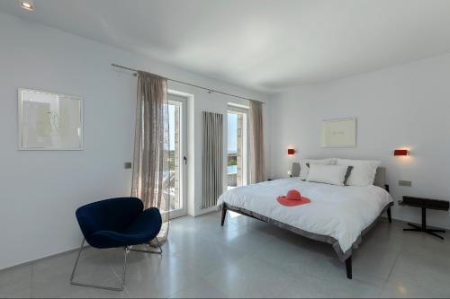 a bedroom with a bed with a red hat on it at Villa Paleopoli in Kythira