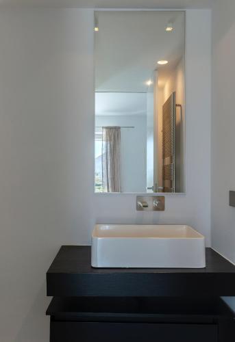 a bathroom with a white sink and a mirror at Villa Paleopoli in Kythira
