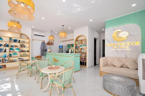 a living room with a table and chairs and a couch at Casa Del Mar Hotel & Apartment - Sunset Town, Phu Quoc in Phú Quốc