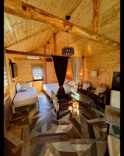 a room with a bed and a couch and a table at Drveni san Senović 2 in Banja