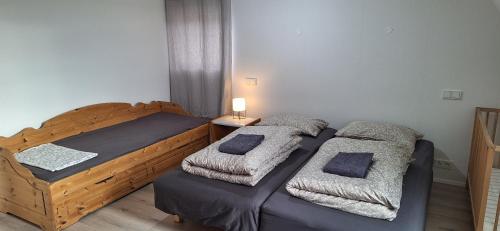 a bedroom with two beds and a table with a lamp at Cottage in the middle of nowhere in Ölfus