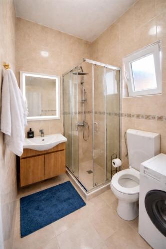 a bathroom with a shower and a toilet and a sink at Apartman VUKAN in Budva