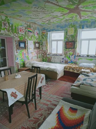 a room with two beds and a wall covered in graffiti at Ubytování v galerii in Zlatá Olešnice