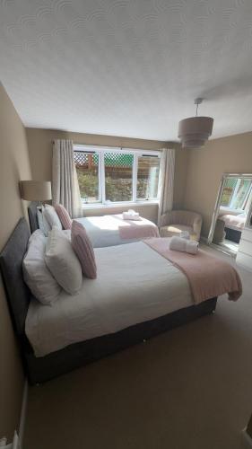 a bedroom with two beds and a window at Fairwinds in Inverness