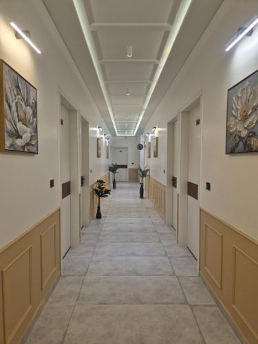 an empty hallway in a building with paintings on the walls at Shri banke bihari complex in Jalesar