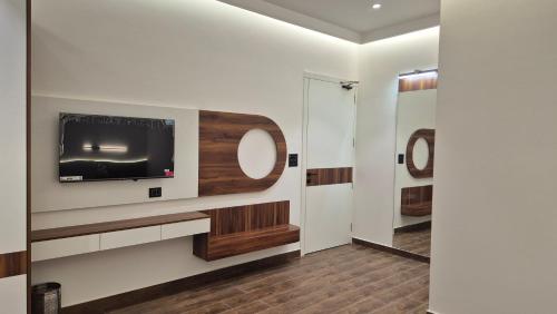 a room with a tv and a mirror at Shri banke bihari complex in Jalesar
