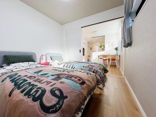 a bedroom with a bed and a dining room at KUROFUNE久我山ハウス,shibuya 13min,Kichijoji3min in Kugayama