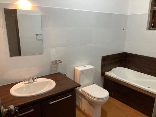 a bathroom with a sink and a toilet and a tub at Sky Mansion Athurugiriya in Athurugiriya