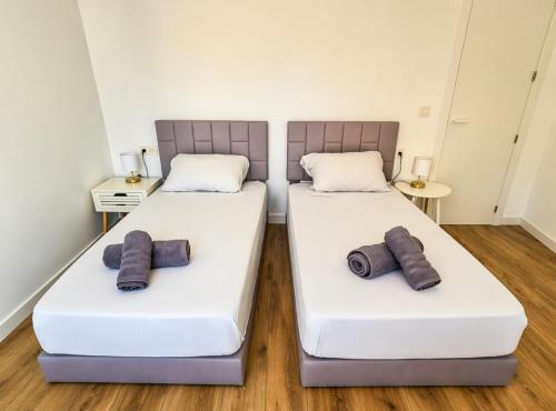 two beds in a room with two pillows on them at Casa Del Sol in Águilas