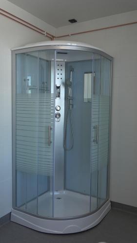 a shower with a glass enclosure in a room at Villa Karijoki in Karijoki