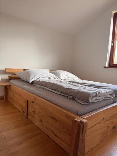 a bed with a wooden frame in a room at Ferienhof Vielstedt in Schürenbusch