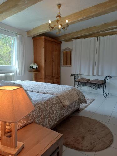 a bedroom with a bed and a lamp on a table at Villa la Myreclose in Saint-Auban