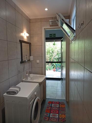 a bathroom with a washing machine and a sink at Maria's House Kontokali in Kontokali